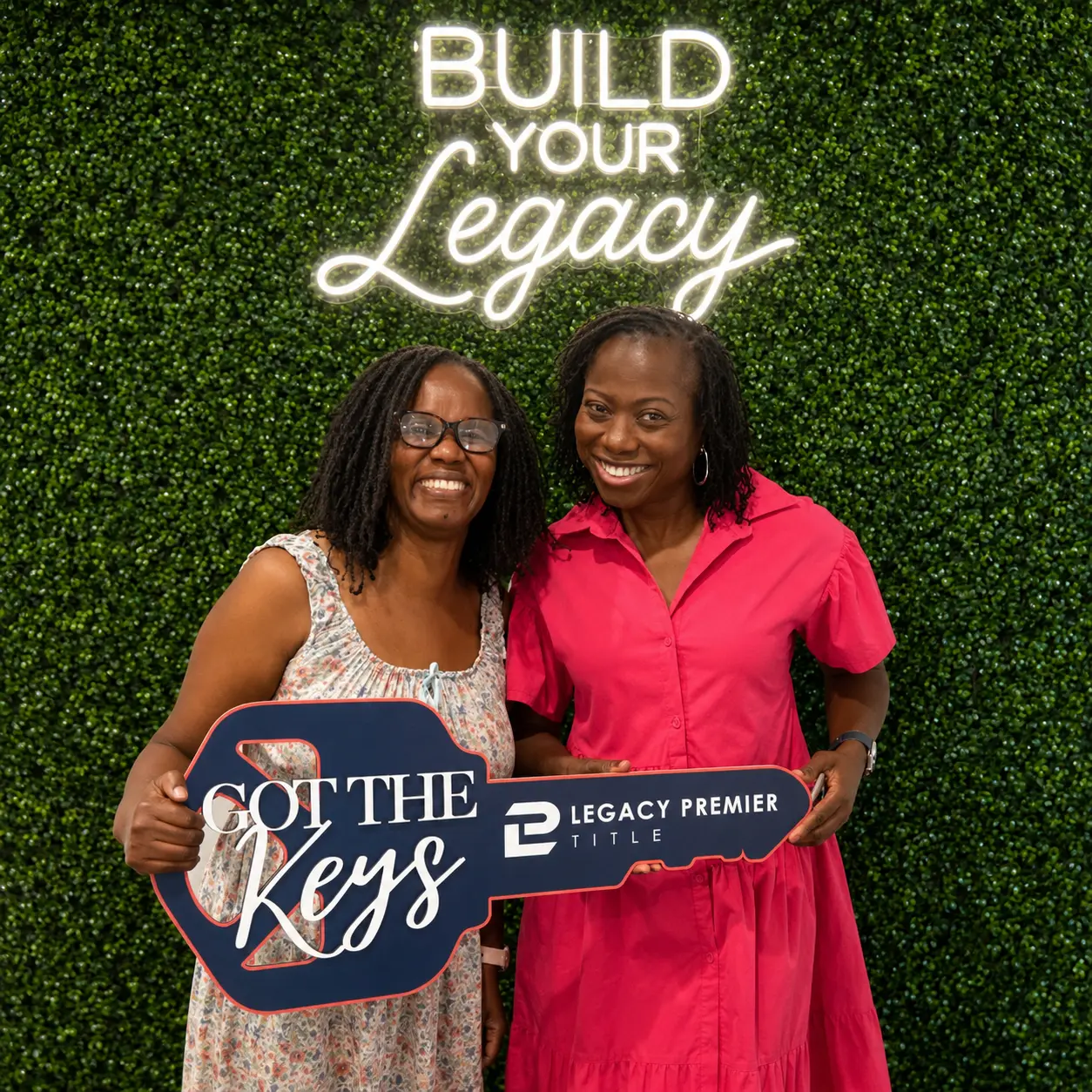Two clients celebrating their closing at Legacy Premier Title