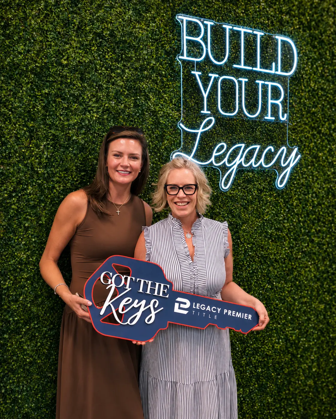 Two clients holding the Got the Keys sign